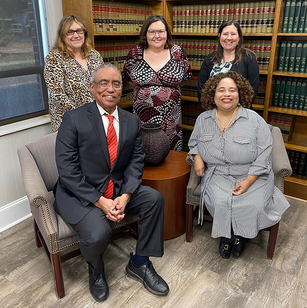 Judge Thompson seated with staff from Legal Services of Alabama