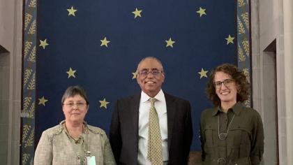 judge and visitors standing behind the bench