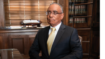 Judge Thompson seated in his library