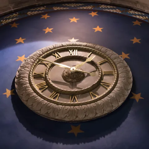 Golden Clock Over Blue Background
