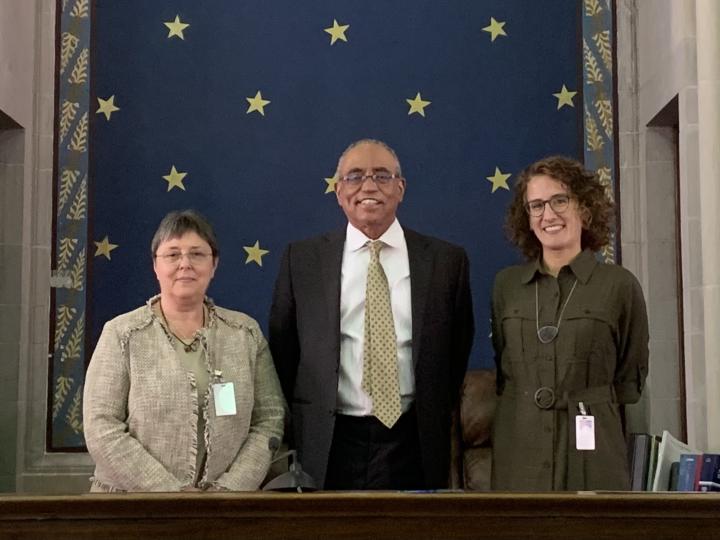 judge and visitors standing behind the bench