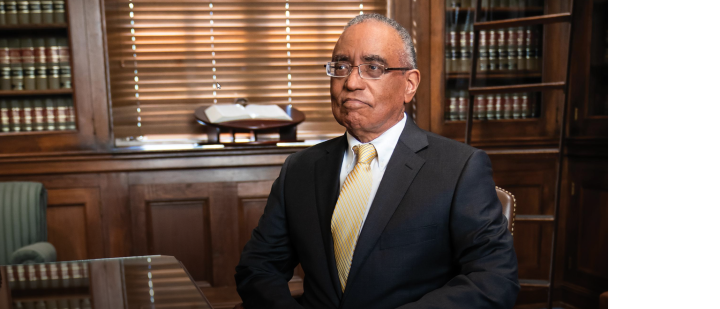 Judge Thompson seated in his library